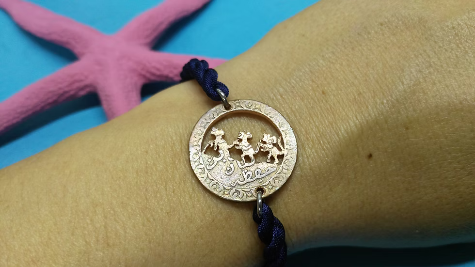 Three blind mice bracelet on a Zanzibar coin.